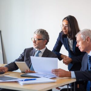 Concentrated partners using laptop and working with documents